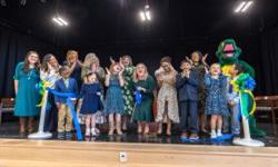  Cutting the ribbon on stage at Knights View Elementary